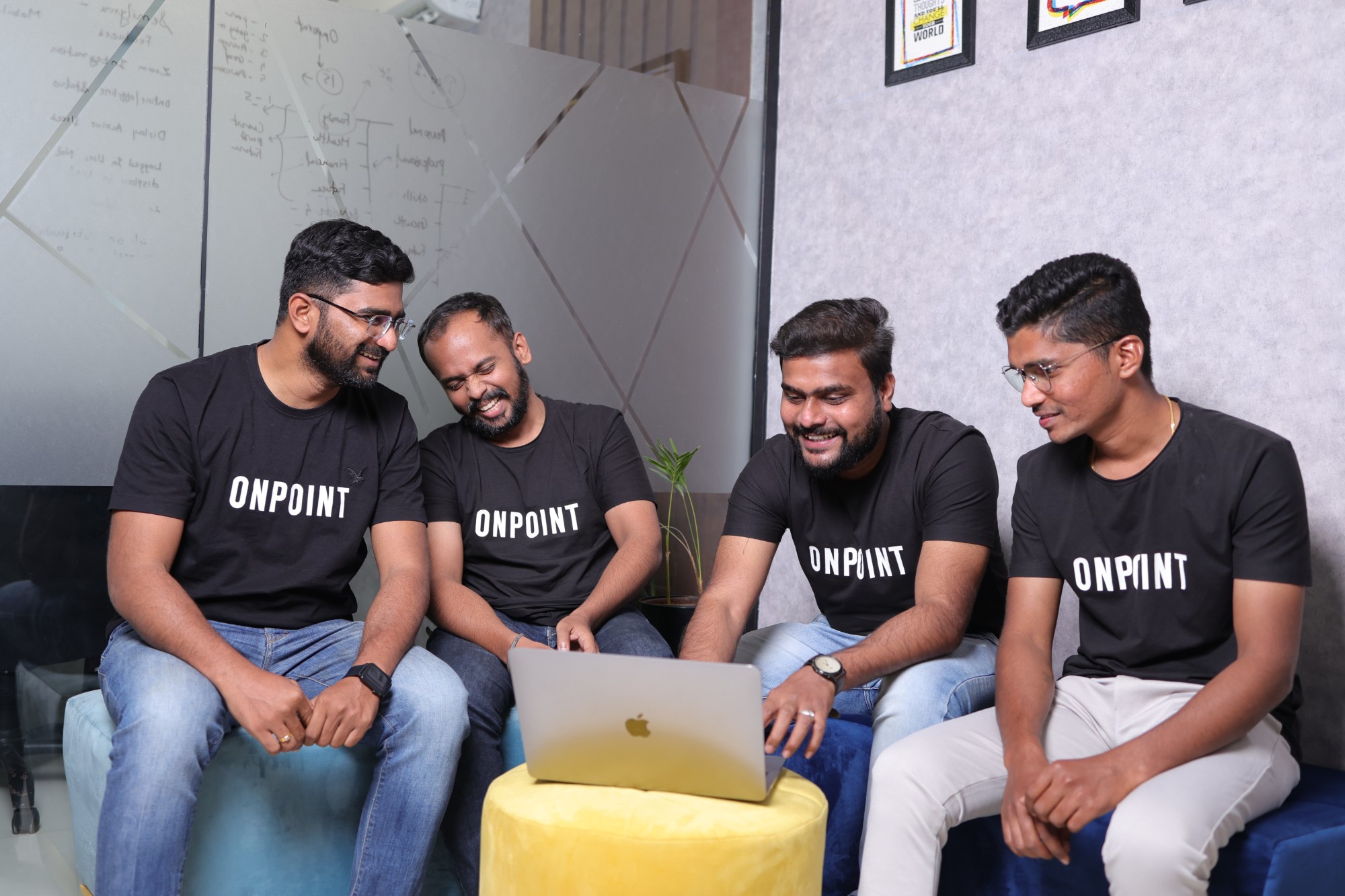OnPoint team collaborating on a laptop